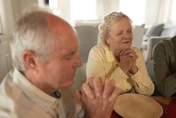 A photograph of a couple praying together.