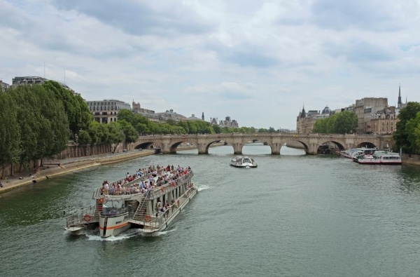 A photograph of a cruise going down a river.